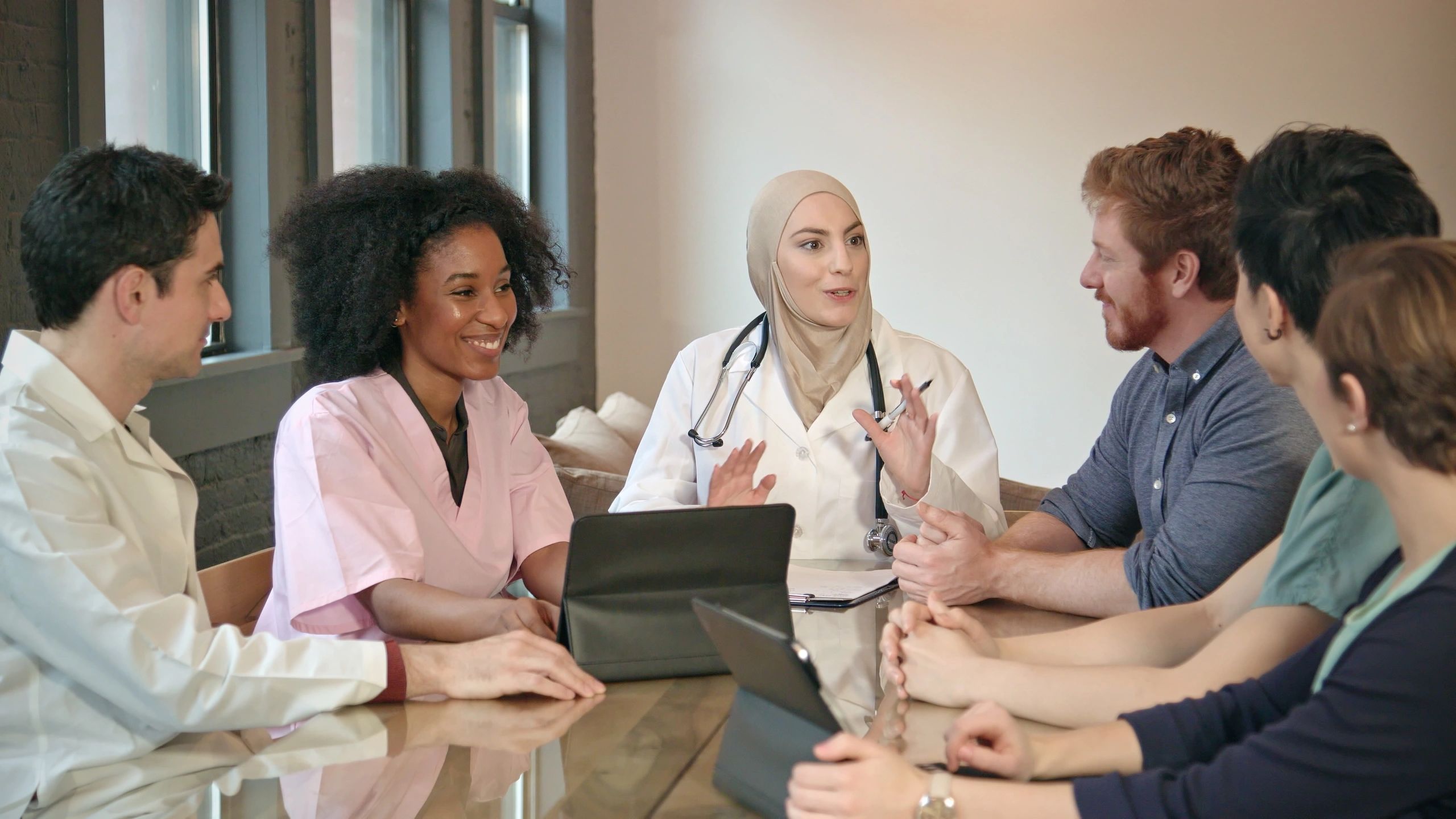 Healthcare professionals meeting to review compliance and advisory plans